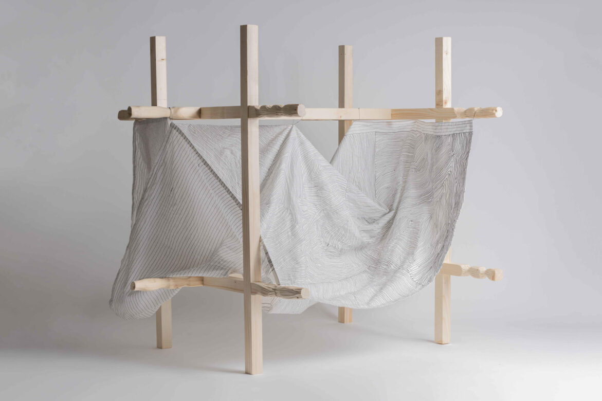 Model. Embroidery (on machine) on cotton fabric. Frame of pine wood, carved in its ends.